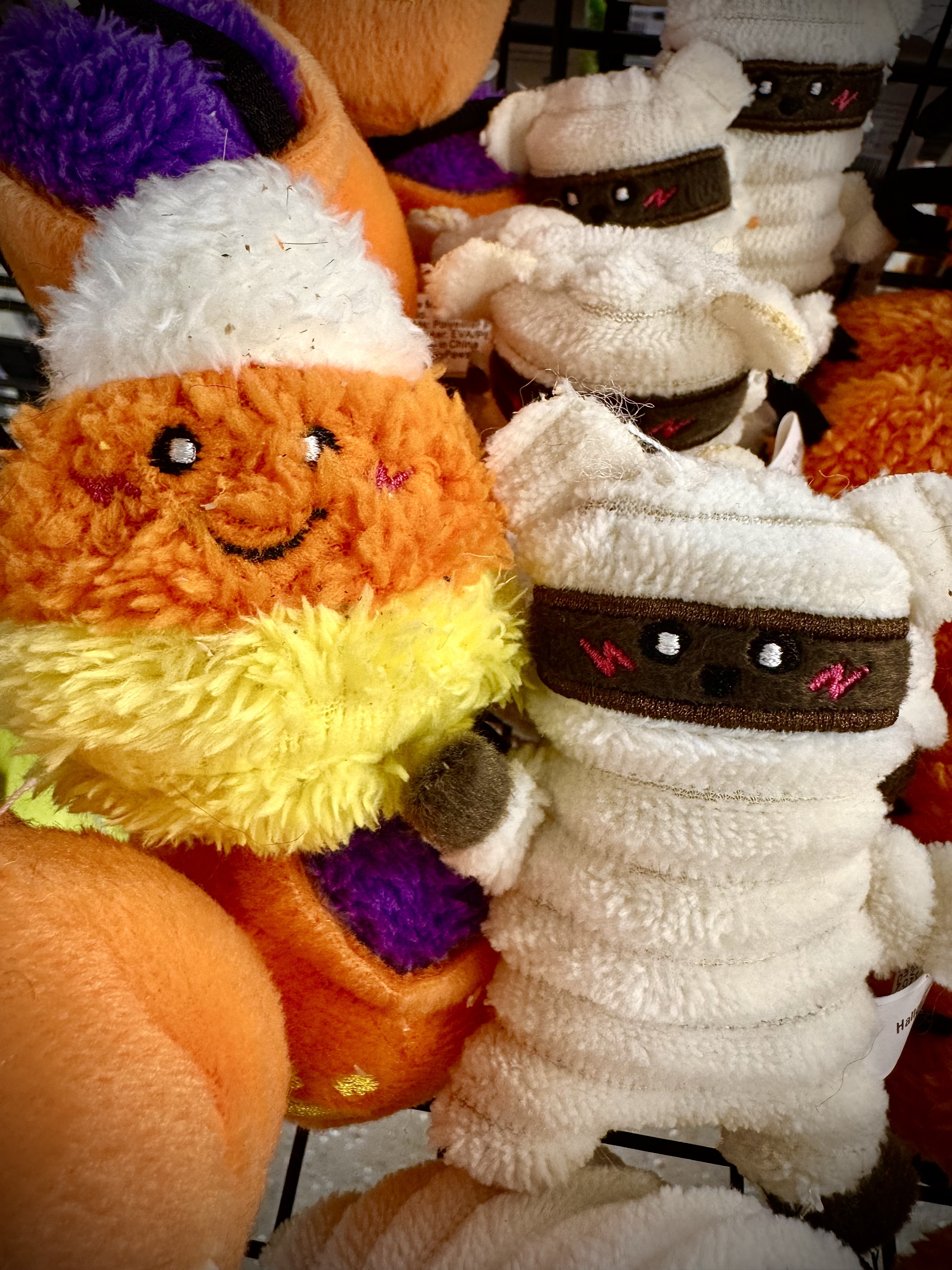Candy corn and mummy plush Halloween toys at Wishbone Pet Co.